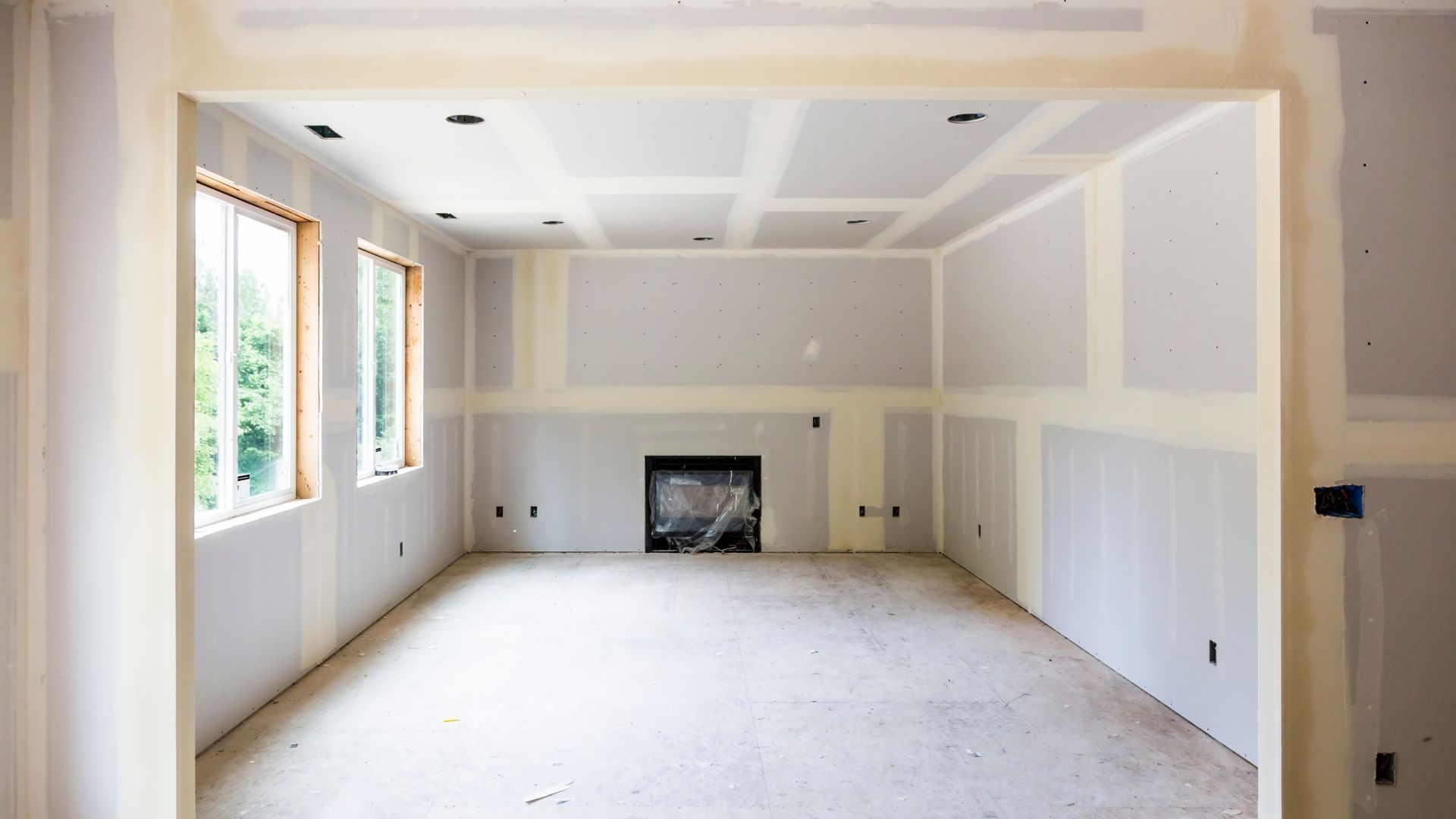 An empty room with a fire place in the middle