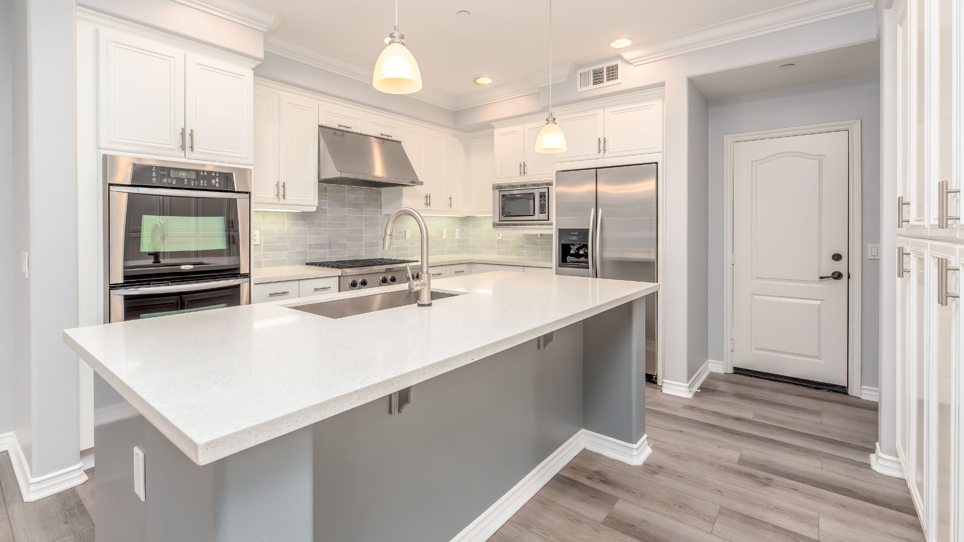 A large kitchen with a center island and stainless steel appliances