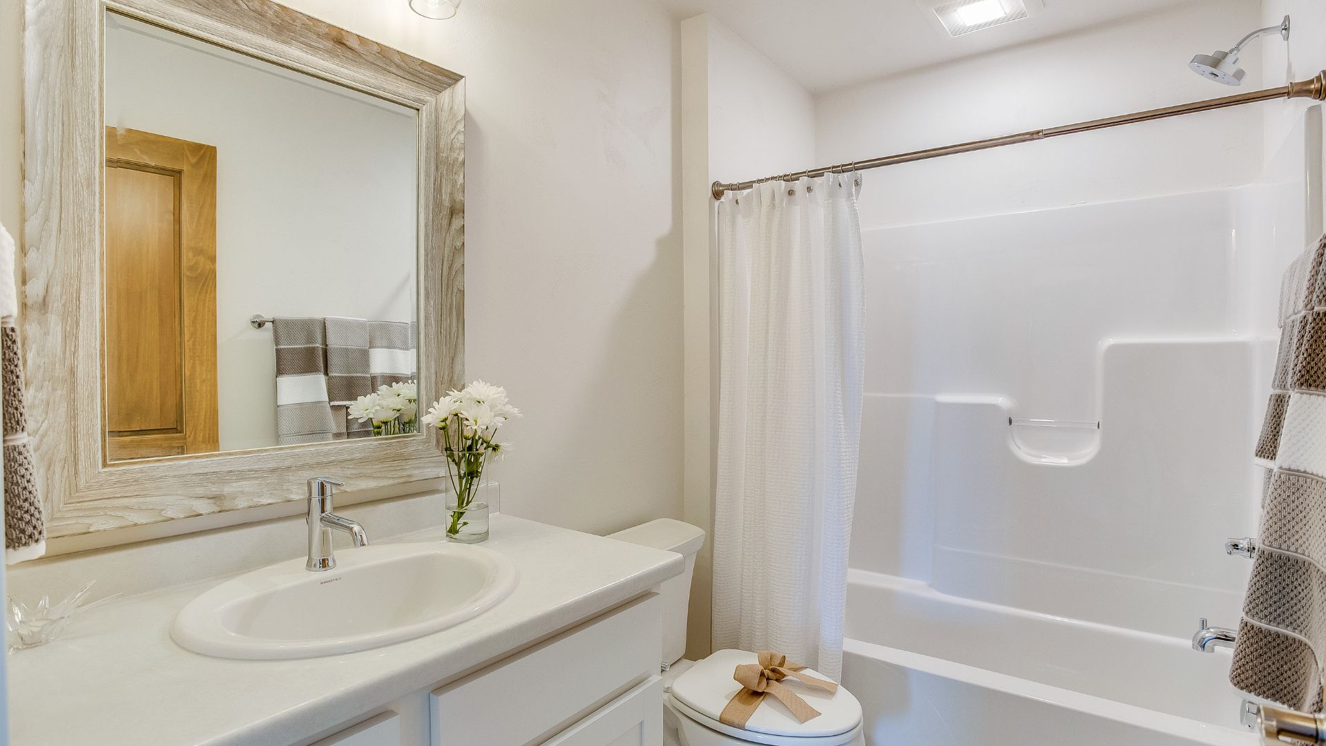 A bathroom with a sink, toilet, and bathtub