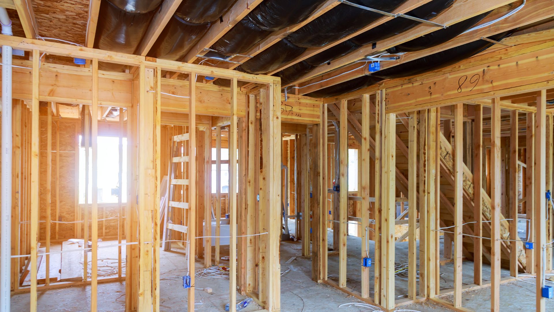 A house under construction with a lot of wood framing